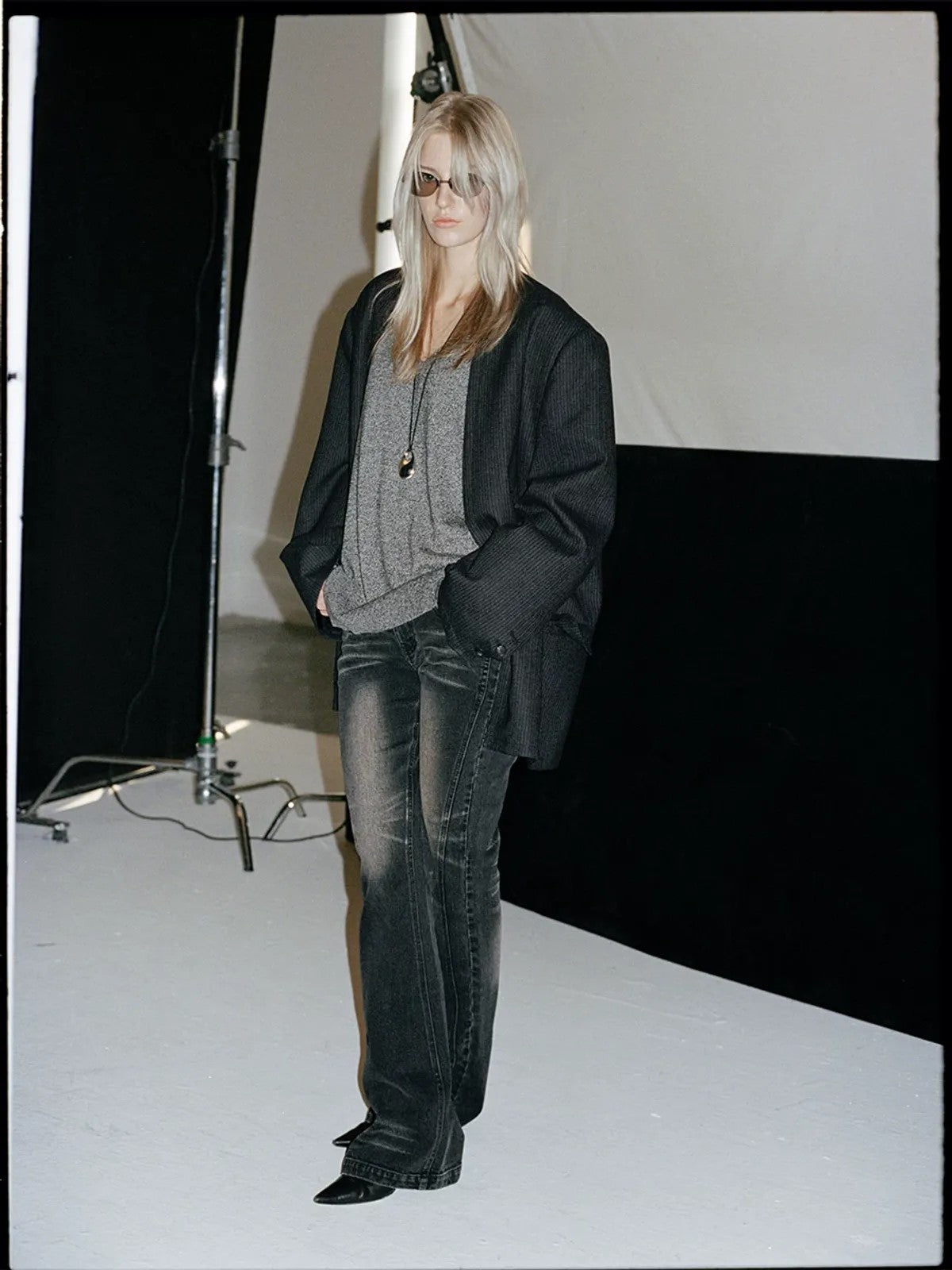 ACSENSE STUDIO Whiskered Micro Flare Jeans in Black - On Model